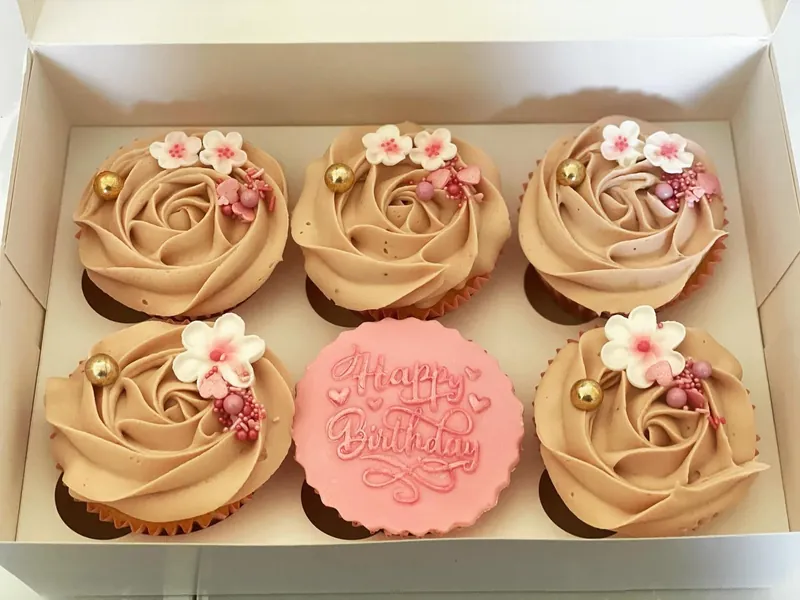 Caramel rose cupcakes with sugar blossoms and a Happy Birthday disc