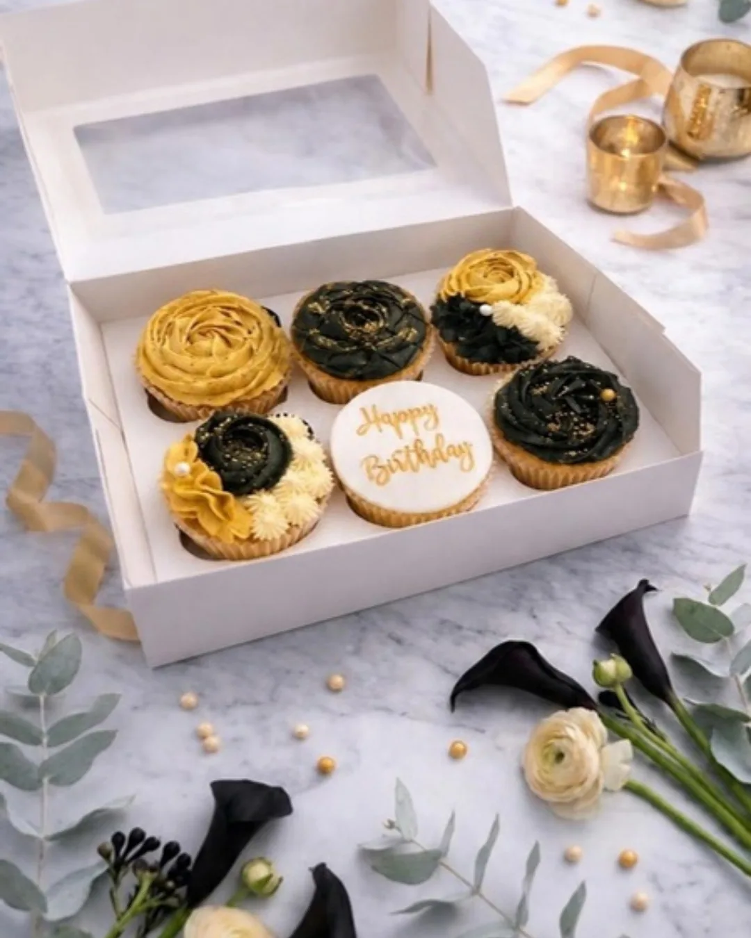 Black and gold rose cupcakes with a Happy Birthday disc in a white gift box