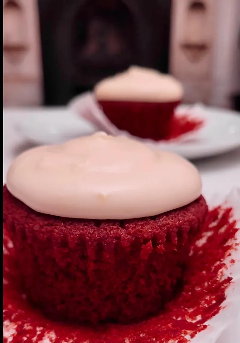 Close-up of a red velvet cupcake with smooth cream cheese frosting